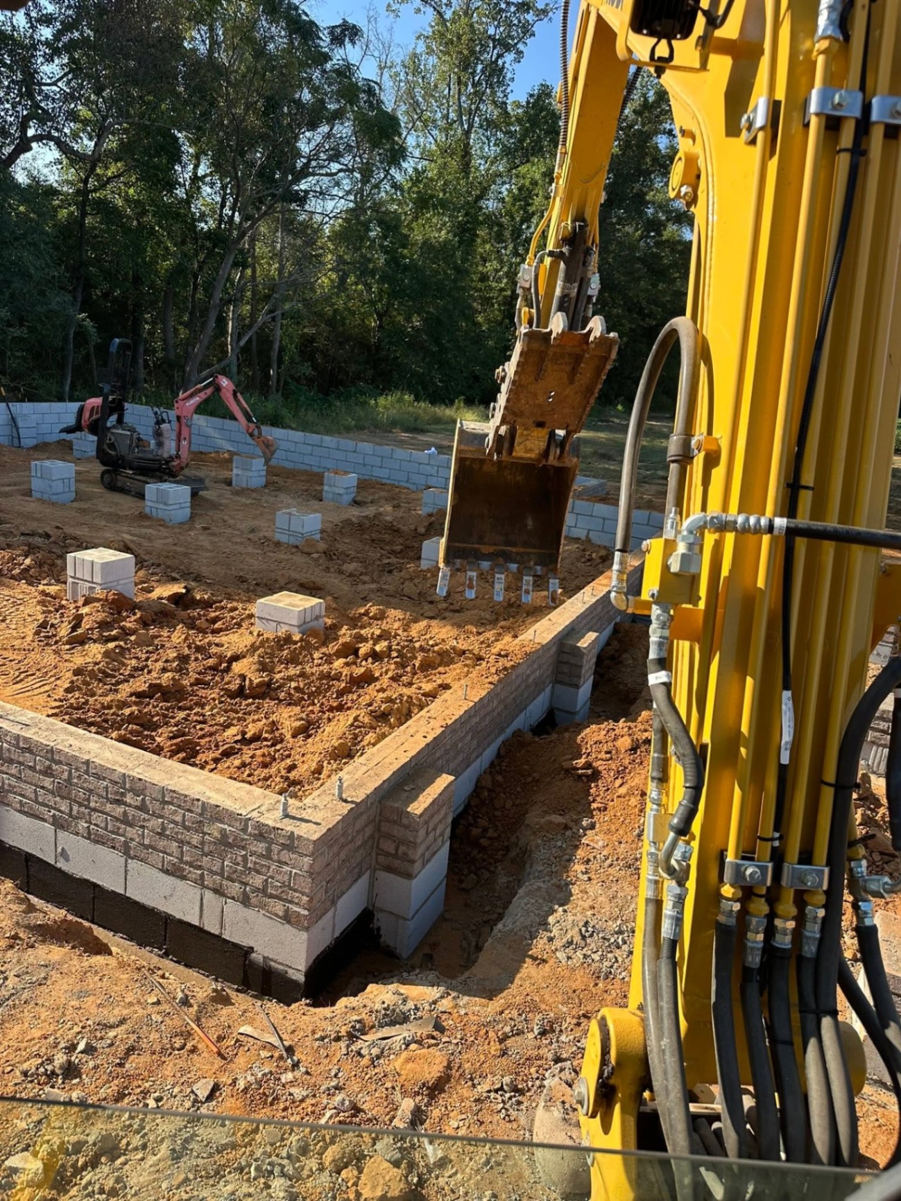 Triple H Land Management excavator working on a new home foundation in Johnston County, NC